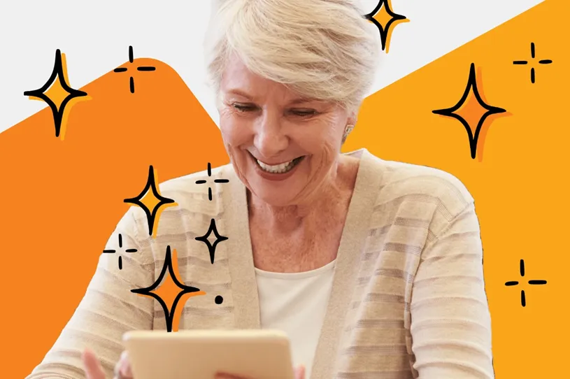 Teacher smiling as she works on an electronic...