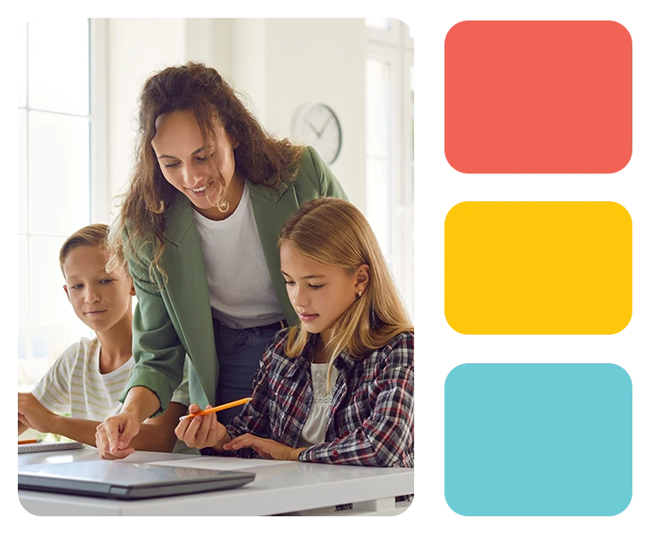 smiling students looking at a laptop