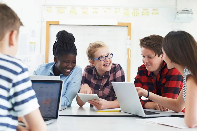 Group of middle school students smiling using...