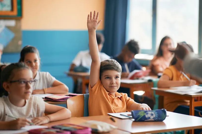 A student raising their hand in class