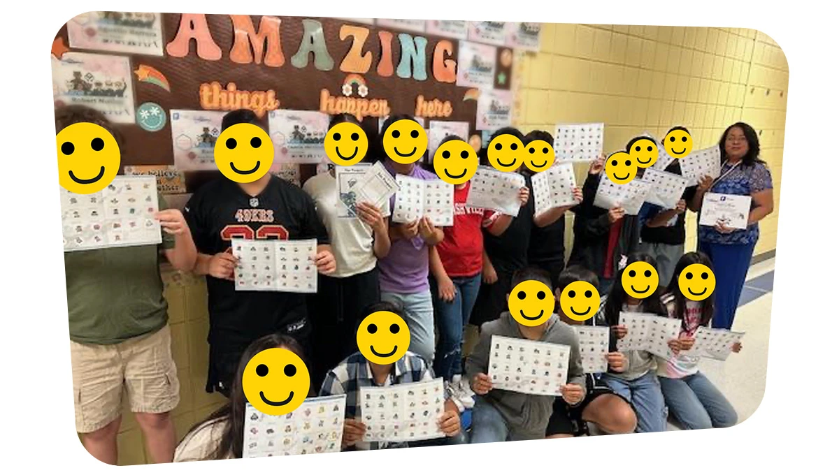 The entire classroom is gathered in front of a bulletin board.