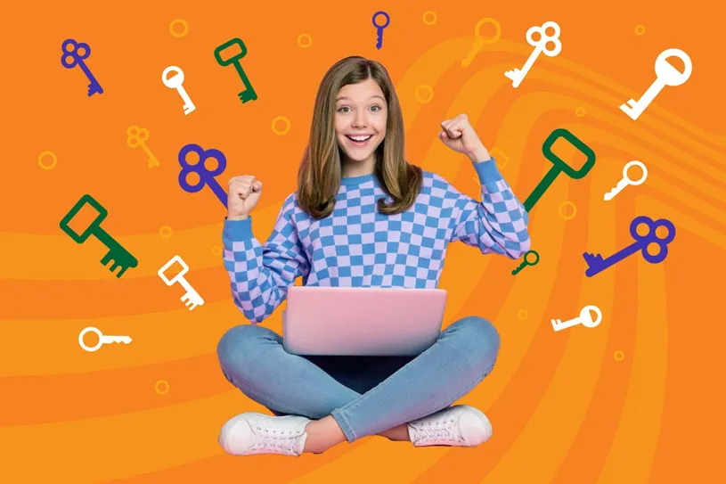 Girl with laptop celebrating. She is sitting in...