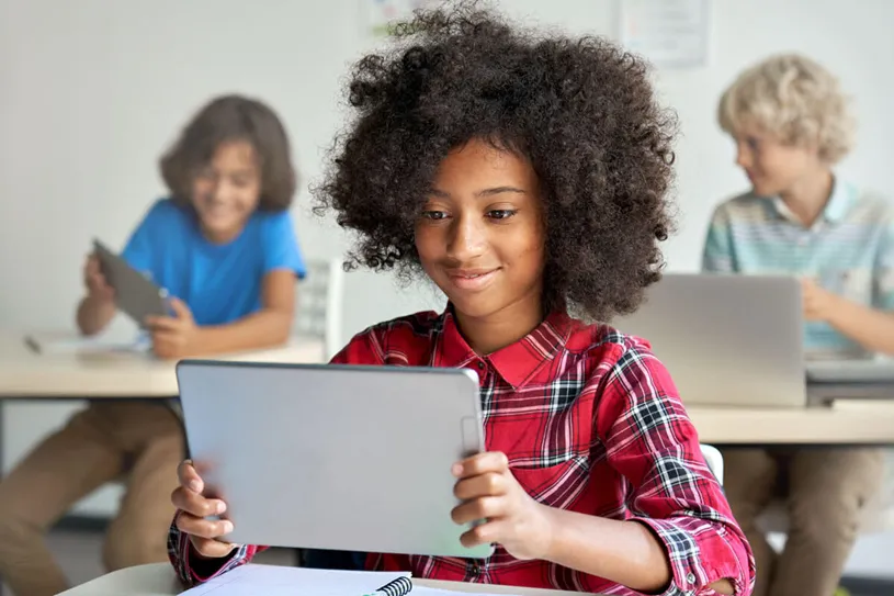 Students using devices while sitting at desks