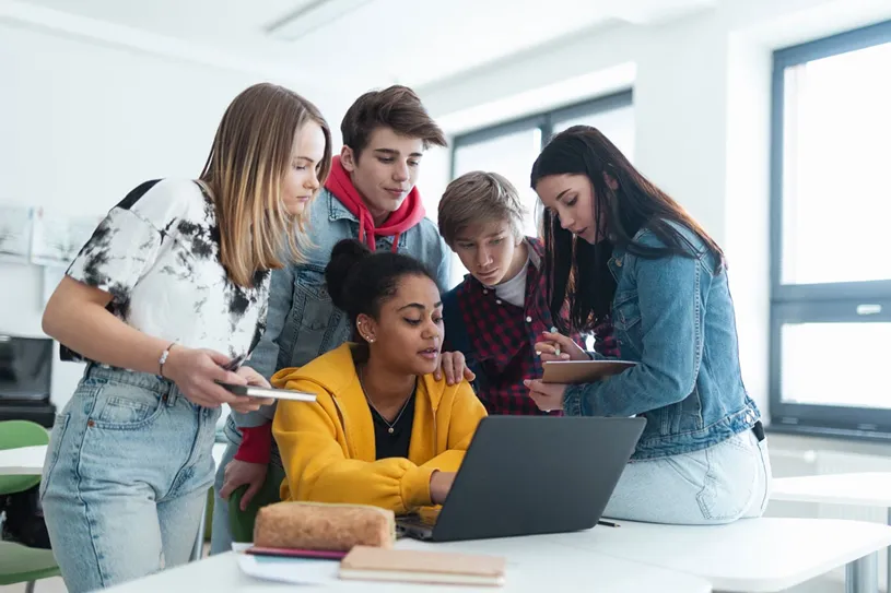 Group of students learning together in the...