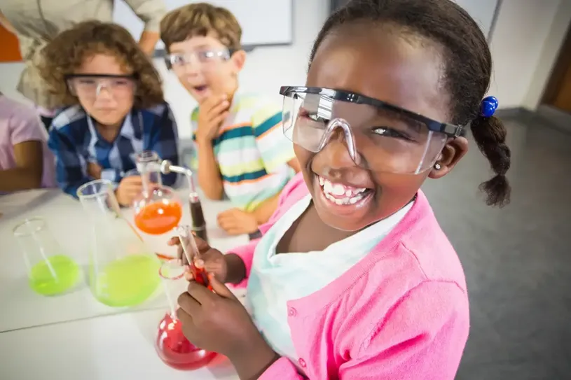 Kids doing a chemical experiment in laboratory at...