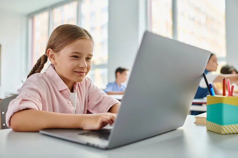 Girl learning with a laptop during class