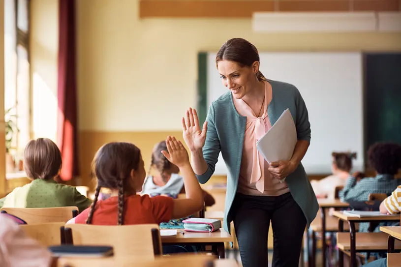 Teacher encourages students and gives a high five